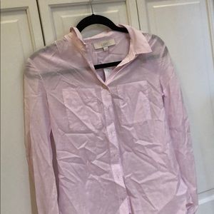 A pale pink button down shirt
